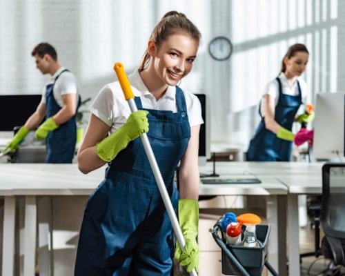 smiling-cleaner-washing-floor-and-smiling-at-camer-2023-11-27-05-05-34-utc